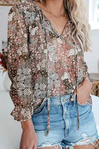 Detailed view of women's boho floral print blouse with V-neck and drawstring detail.