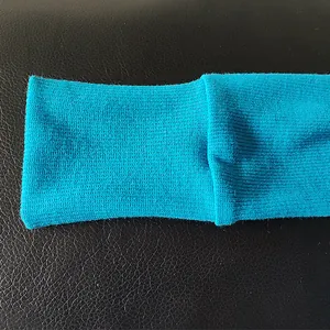 Close-up detail of the vibrant blue ribbed knit cuff of a solid color bodysuit