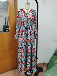 Detailed view of V-neck Bohemian printed maxi dress with abstract colorful leopard pattern.