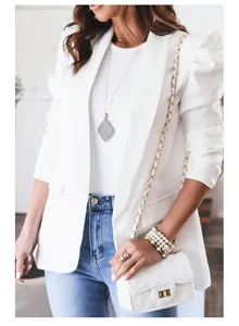 Close-up view of a white long-sleeved lapel suit jacket with stylish puffed sleeves.
