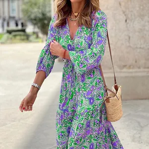 Detailed view of vibrant bohemian paisley floral print on V-neck long sleeve maxi dress