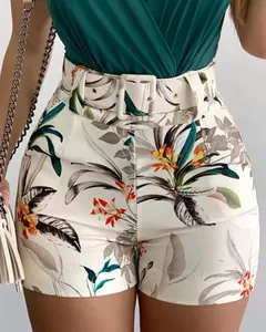 Close-up of tropical leaf print high-waisted shorts with matching belt and V-neck top