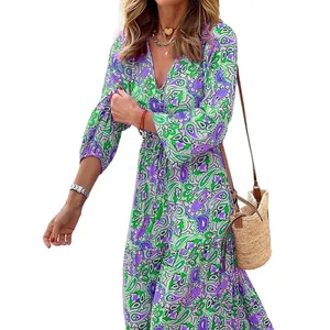 Detail view of a Bohemian paisley print maxi dress with V-neck and long sleeves.