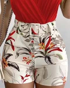 Detail of high-waisted botanical print shorts with matching wide belt and red top