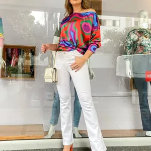 Stylish women's long sleeve top featuring a vibrant colorful geometric swirl print design