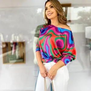 Vibrant geometric print long-sleeve women's top featuring an off-the-shoulder fit.