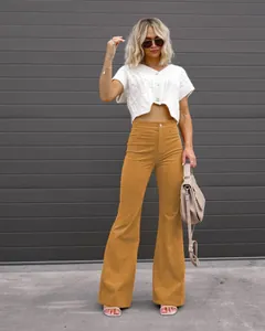 High waisted corduroy flared pants for women in mustard yellow shown on a model