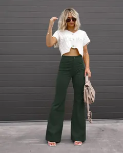 Dark green high waist corduroy flared pants for women in a street style look