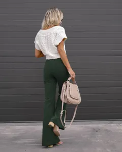 Elegant back view of high waist dark green corduroy flare pants with cable knit sweater