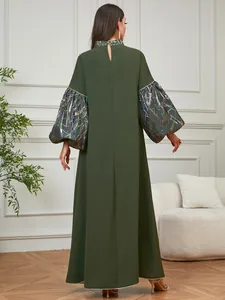 Back view of elegant olive green kaftan dress featuring metallic gold foil lantern sleeves