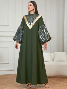 Full view of elegant dark green modest gown with gold sequin and foil detailing.
