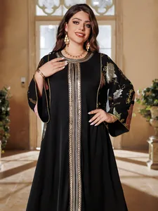 Detail of elegant black kaftan with intricate gold sequin embroidery and floral patterns