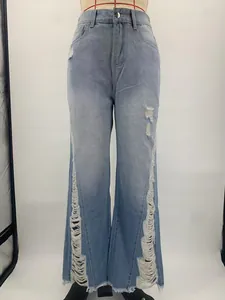 Detailed view of light blue flare jeans featuring unique heavy side distressing effects