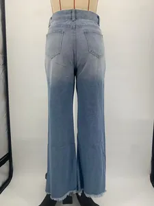 Detailed back view of light blue high-waisted flared jeans with frayed hem on mannequin
