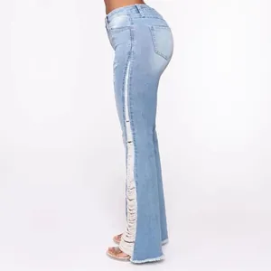 Side detail of light blue flare jeans featuring stylish distressed ripped side seams