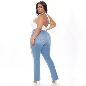 Close-up rear view of curvy model wearing light blue plus size flared denim jeans.