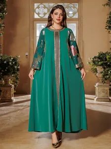 Full detail view of the elegant green maxi dress featuring gold sequin floral embroidery.