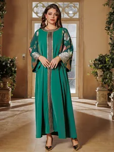 Elegant emerald green kaftan dress with detailed gold and silver sequin embroidery.