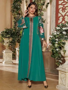 Elegant emerald green long-sleeved maxi dress with gold embroidery and floral sequins