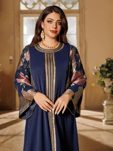 Detailed macro view of the elegant navy blue dress with gold embroidery and floral sequins