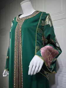Detailed view of intricate sequin embroidery on an elegant emerald green long dress