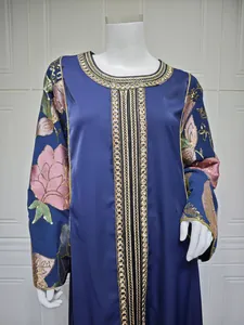 Detailed view of blue maxi dress featuring gold and pink sequin floral embroidery