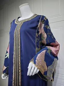 Close-up of navy blue dress with intricate gold sequin floral embroidery on sleeves.