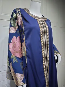 Close-up of an elegant blue dress featuring floral embroidery and sequin detailing