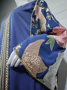 Detailed view of intricate sequin floral embroidery on a blue elegant long dress