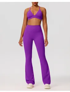 Paarse yoga broek met wijde pijpen en bijpassende V-hals sportbeha op model in studio