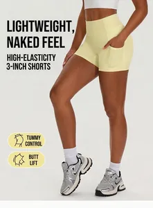 Close-up of high-waisted yellow yoga shorts with side pockets on model