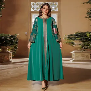 Elegant emerald green long dress with gold sequin floral embroidery on sleeves.