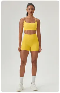 Detailed view of a yellow two-piece yoga set with a sports bra and high-waisted shorts