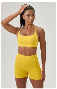 Front view of a yellow yoga set including a sports bra and high-waist shorts on a model
