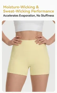 Close-up detail of high-waisted pale yellow yoga shorts with functional side pockets.