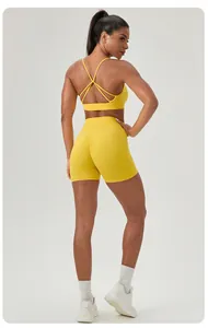 Detailed back view of yellow strappy sports bra and high-waist scrunch butt shorts set.