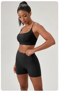Sexy black two-piece yoga set with sports bra and high-waist shorts for fitness.