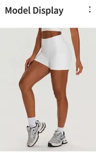Detailed view of white high-waist yoga shorts with functional side pockets for gym training