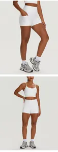 White two-piece yoga set with high-waist pocket shorts and strappy sports bra for fitness