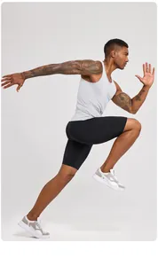 Action shot of man wearing grey athletic compression tank top and black shorts.