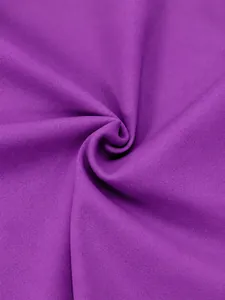 Macro view showing the soft texture of purple high-stretch yoga fabric with 75% nylon 25% spandex