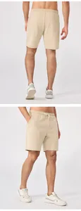 Detalle de pantalones cortos beige para hombre con cordón, vista de espalda y bolsillos.