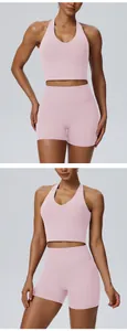 Close-up detail of light pink yoga set featuring halter bra and high-waist sports shorts