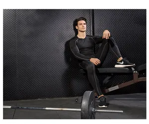 Model wearing black compression set during gym workout showcasing fit and flexibility
