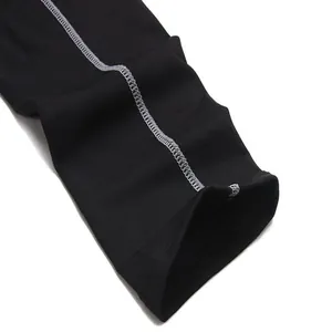 Close-up detail of grey flatlock stitching on black PRO athletic compression pants