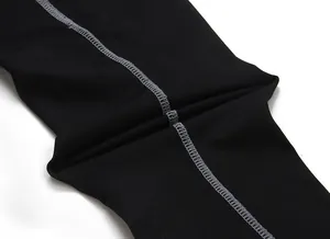 Macro view of professional grey flatlock stitching on black compression training leggings
