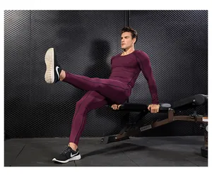 Detailed close-up of men's burgundy elastic compression fitness suit during gym training