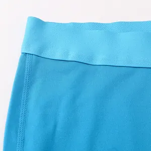Macro view of blue elastic waistband and breathable fabric of women's sports leggings