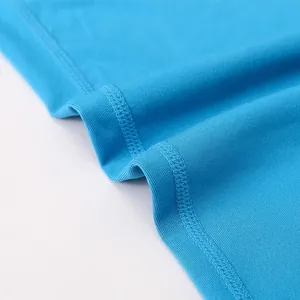 Detailed close-up of blue moisture-wicking fabric with flatlock stitching for yoga pants
