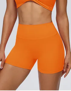 Detailopname van een feloranje korte yogabroek met hoge taille en naadloos push-up design